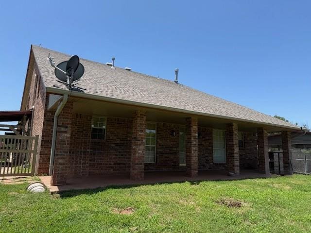 13501 E Memorial Rd, Jones, OK 73049 - back of house with brick siding and a patio area