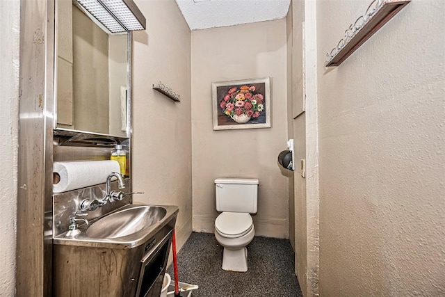 1028 N 11th St, Chickasha, OK 73018 - bathroom featuring vanity and a textured ceiling