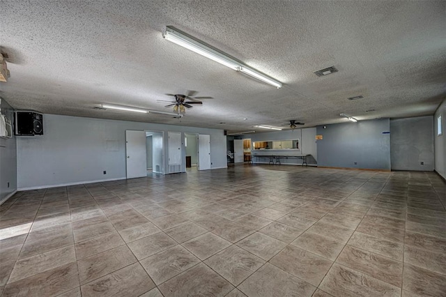 1028 N 11th St, Chickasha, OK 73018 - garage with a ceiling fan and baseboards