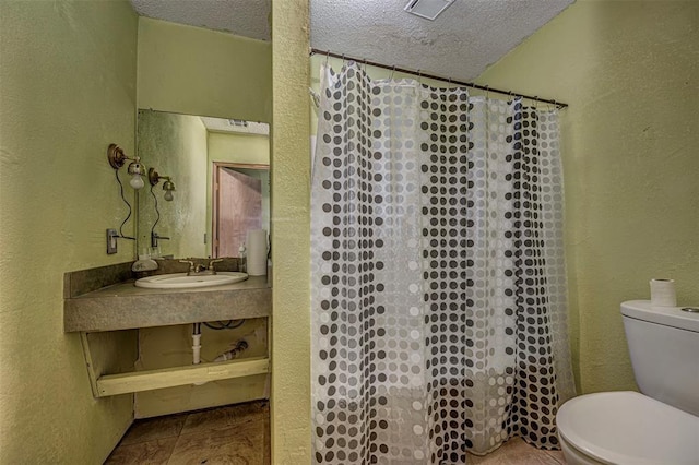 1028 N 11th St, Chickasha, OK 73018 - bathroom with a textured ceiling, a textured wall, and a shower with shower curtain