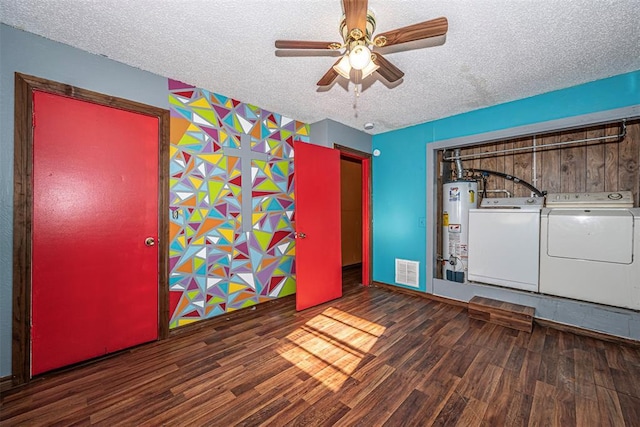 1028 N 11th St, Chickasha, OK 73018 - empty room with water heater, wood finished floors, a textured ceiling, separate washer and dryer, and a ceiling fan