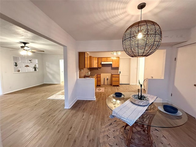 1402 S 14th St, Chickasha, OK 73018 - dining area with light wood-style floors and ceiling fan