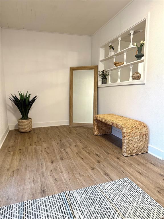 1402 S 14th St, Chickasha, OK 73018 - unfurnished room with wood finished floors and baseboards
