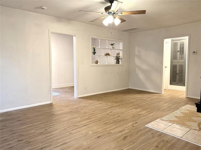 1402 S 14th St, Chickasha, OK 73018 - unfurnished room featuring a ceiling fan, wood finished floors, and a textured ceiling