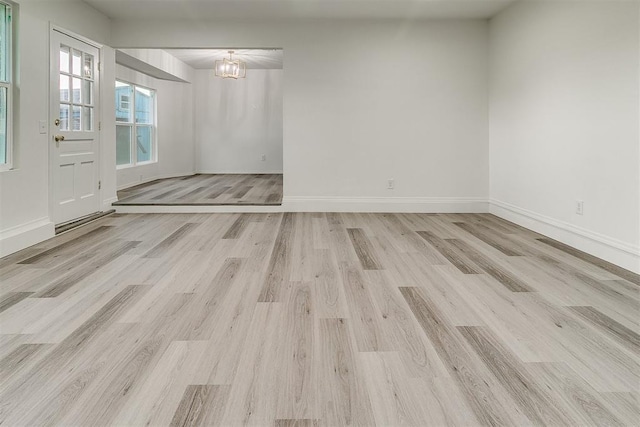 648 NW 18th St, Moore, OK 73160 - unfurnished room featuring light wood-style flooring and a chandelier