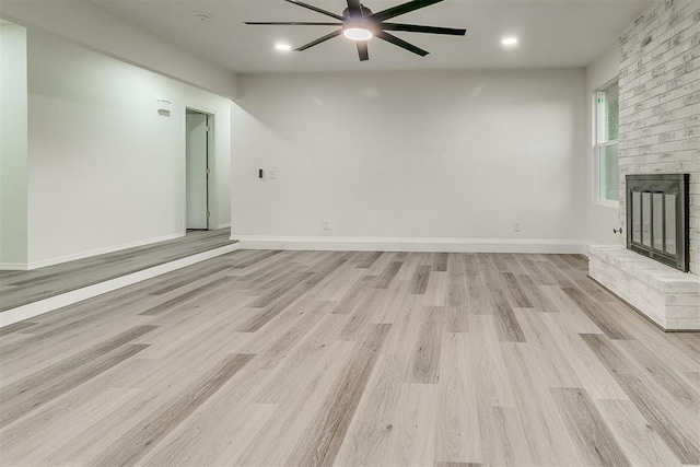 648 NW 18th St, Moore, OK 73160 - unfurnished living room with ceiling fan, light wood-style flooring, a fireplace, and recessed lighting