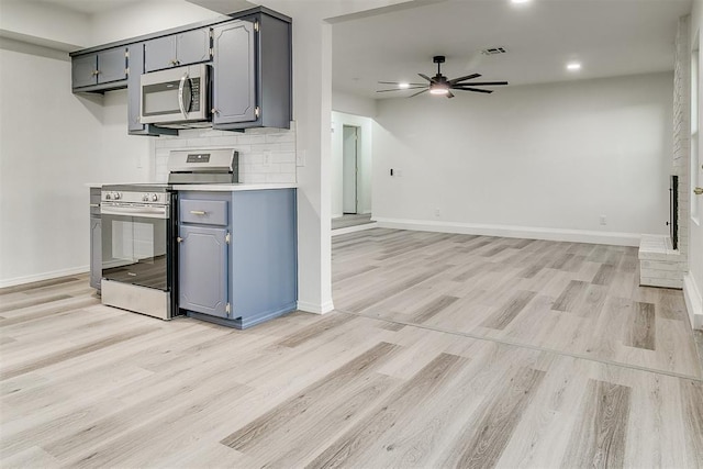 648 NW 18th St, Moore, OK 73160 - kitchen with appliances with stainless steel finishes, gray cabinets, light wood-type flooring, and recessed lighting