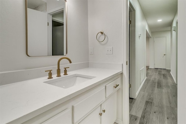 648 NW 18th St, Moore, OK 73160 - bathroom with vanity, wood finished floors, and recessed lighting