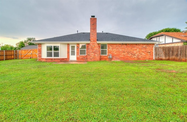 648 NW 18th St, Moore, OK 73160 - back of property featuring a chimney, a fenced backyard, and brick siding