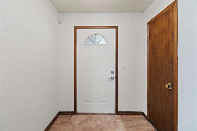 1912 Magnolia Ln, Edmond, OK 73013 - entryway featuring wood finished floors and a textured ceiling