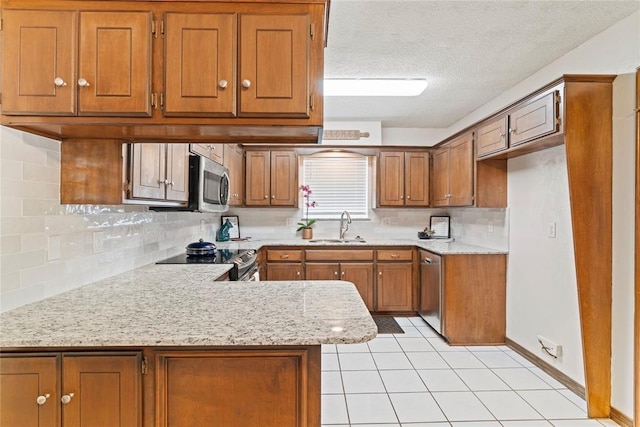 1912 Magnolia Ln, Edmond, OK 73013 - kitchen with brown cabinetry, light countertops, appliances with stainless steel finishes, backsplash, and light tile patterned floors