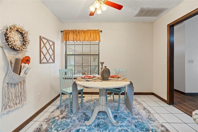 1912 Magnolia Ln, Edmond, OK 73013 - dining space with light tile patterned floors, a ceiling fan, and a textured ceiling