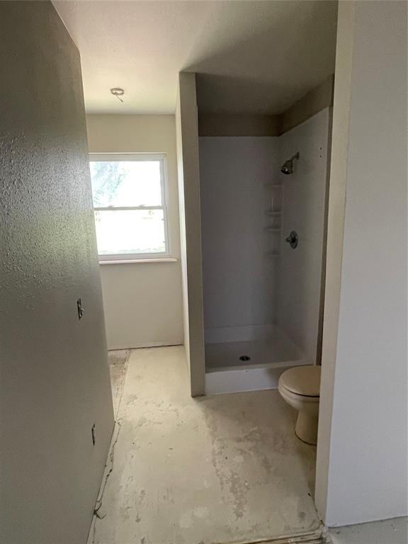 13090 County Road 1140, Lookeba, OK 73053 - bathroom featuring a shower stall and concrete floors