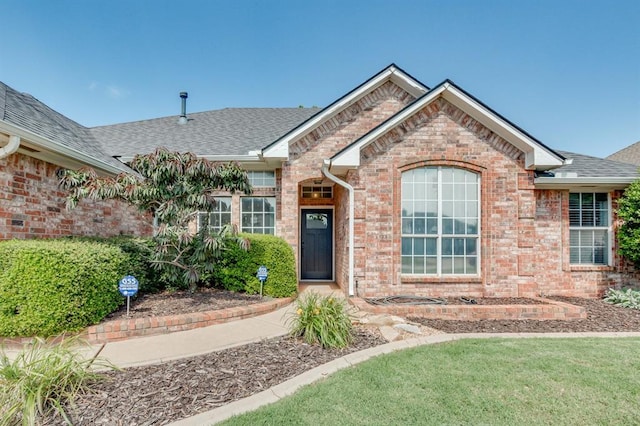 613 N Remington Way, Mustang, OK 73064 - view of front of house featuring brick siding and a shingled roof