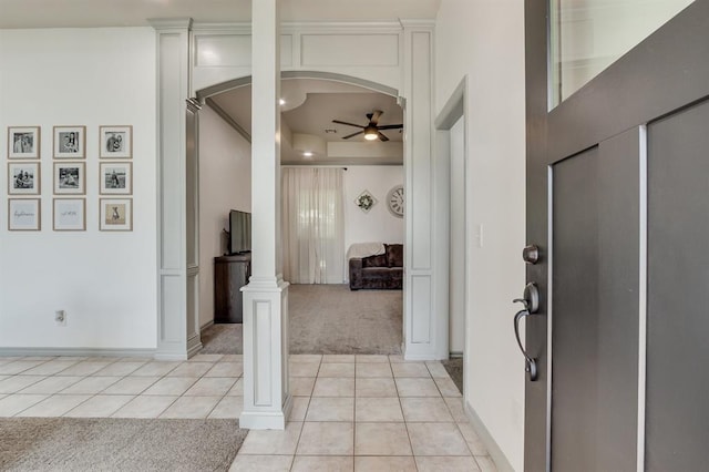 613 N Remington Way, Mustang, OK 73064 - foyer entrance with light carpet, ceiling fan, light tile patterned floors, ornate columns, and arched walkways