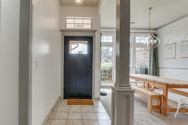 613 N Remington Way, Mustang, OK 73064 - foyer with a chandelier, light tile patterned flooring, and light colored carpet
