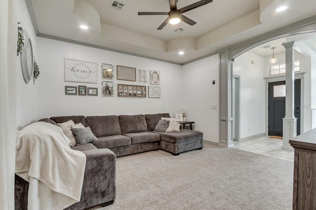 613 N Remington Way, Mustang, OK 73064 - living area featuring arched walkways, ornate columns, light carpet, a ceiling fan, and a tray ceiling