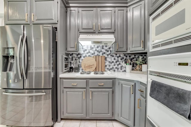 613 N Remington Way, Mustang, OK 73064 - kitchen featuring white appliances, gray cabinetry, and light countertops