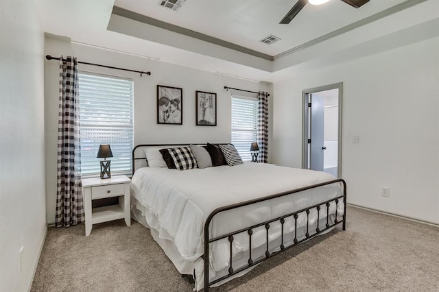 613 N Remington Way, Mustang, OK 73064 - carpeted bedroom featuring crown molding, a ceiling fan, and a tray ceiling
