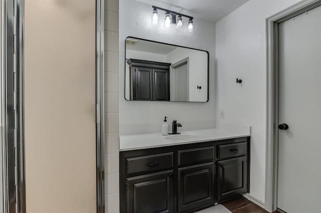 613 N Remington Way, Mustang, OK 73064 - bathroom featuring vanity, a stall shower, and wood finished floors