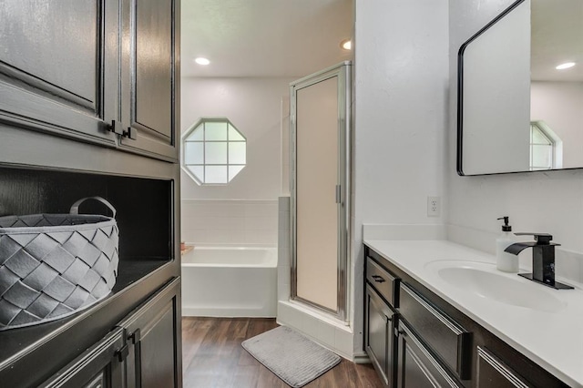 613 N Remington Way, Mustang, OK 73064 - bathroom featuring vanity, wood finished floors, a shower stall, a bath, and recessed lighting