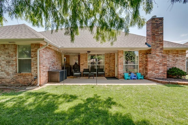 613 N Remington Way, Mustang, OK 73064 - back of house featuring a patio, roof with shingles, and a lawn