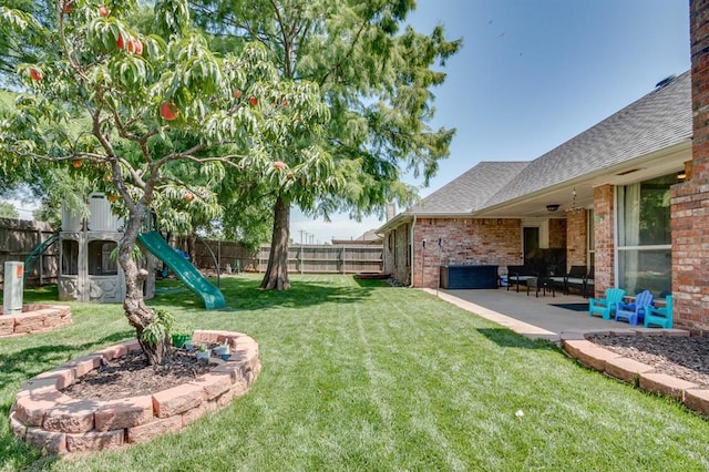 613 N Remington Way, Mustang, OK 73064 - fenced backyard with a playground and a patio area