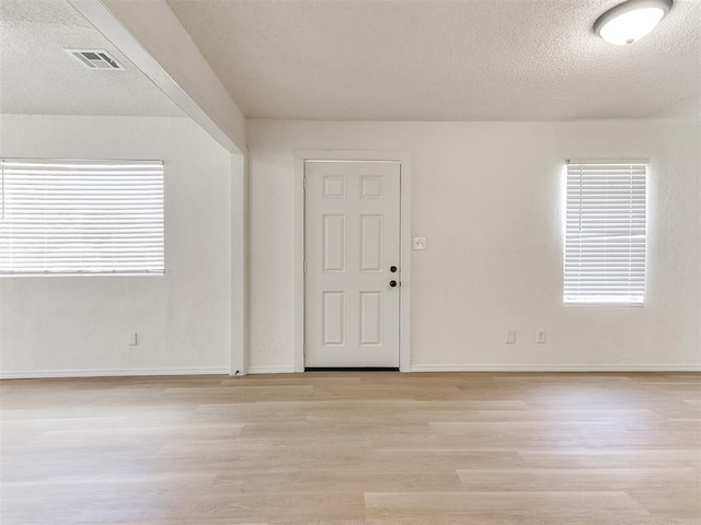 2924 SW 51st St, Oklahoma City, OK 73119 - spare room with light wood-style flooring, a textured ceiling, and plenty of natural light