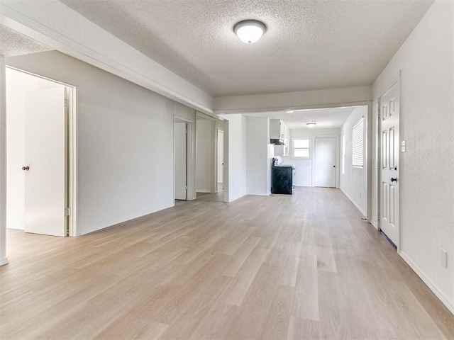 2924 SW 51st St, Oklahoma City, OK 73119 - unfurnished living room featuring light wood-type flooring and a textured ceiling