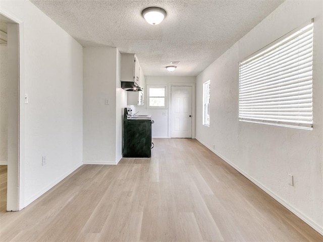 2924 SW 51st St, Oklahoma City, OK 73119 - unfurnished living room with a textured ceiling and light wood-style flooring