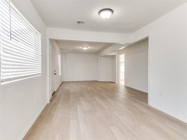 2924 SW 51st St, Oklahoma City, OK 73119 - unfurnished room with light wood-type flooring and a textured ceiling