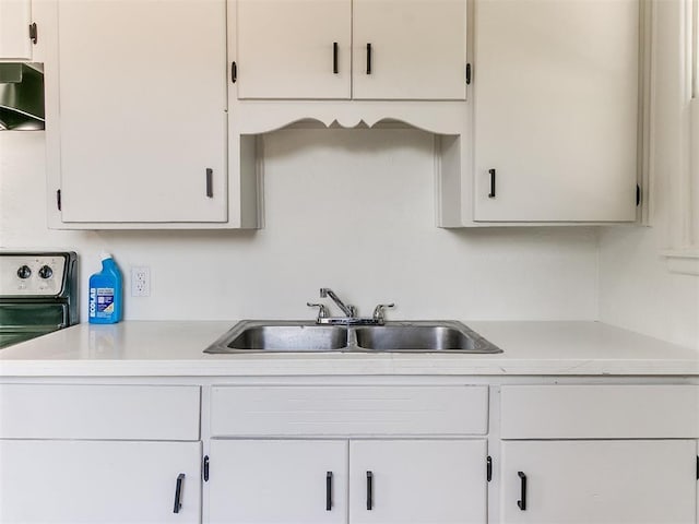 2924 SW 51st St, Oklahoma City, OK 73119 - kitchen with light countertops, ventilation hood, and white cabinetry