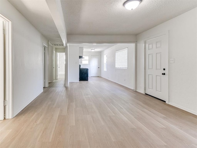 2924 SW 51st St, Oklahoma City, OK 73119 - unfurnished living room featuring light wood-style floors and a textured ceiling