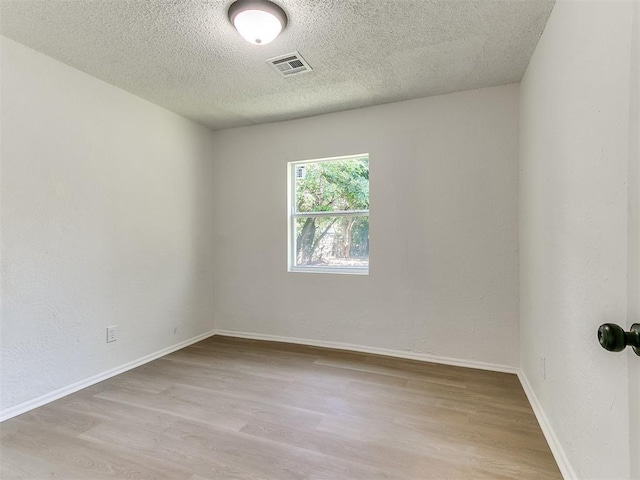 2924 SW 51st St, Oklahoma City, OK 73119 - empty room featuring a textured ceiling and wood finished floors