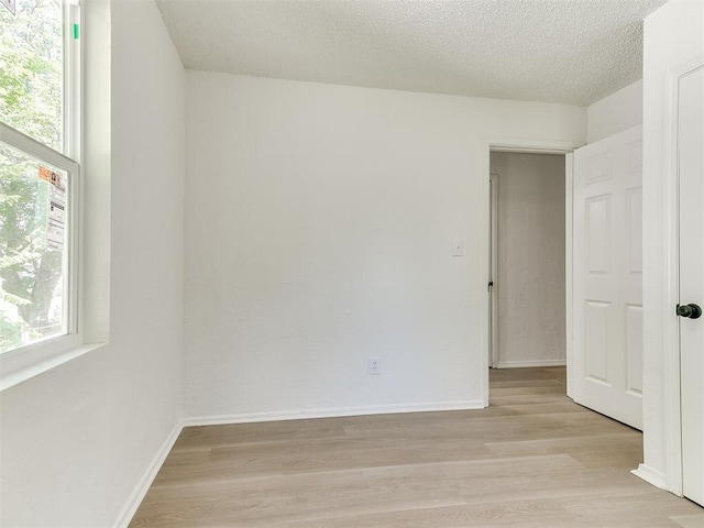 2924 SW 51st St, Oklahoma City, OK 73119 - unfurnished room with plenty of natural light, light wood-type flooring, and a textured ceiling