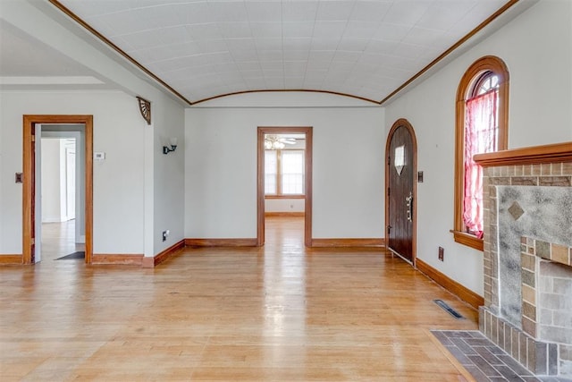 2705 NW 21st St, Oklahoma City, OK 73107 - entryway featuring a fireplace with flush hearth, light wood-type flooring, a ceiling fan, and ornamental molding