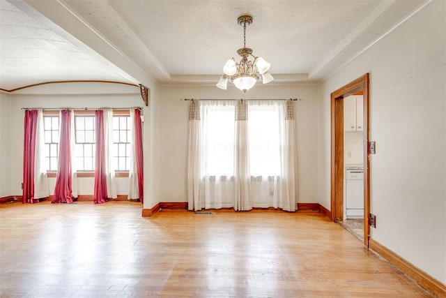 2705 NW 21st St, Oklahoma City, OK 73107 - spare room featuring a chandelier and light wood-style floors