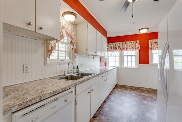 2705 NW 21st St, Oklahoma City, OK 73107 - kitchen featuring white appliances, light countertops, ceiling fan, white cabinetry, and wainscoting