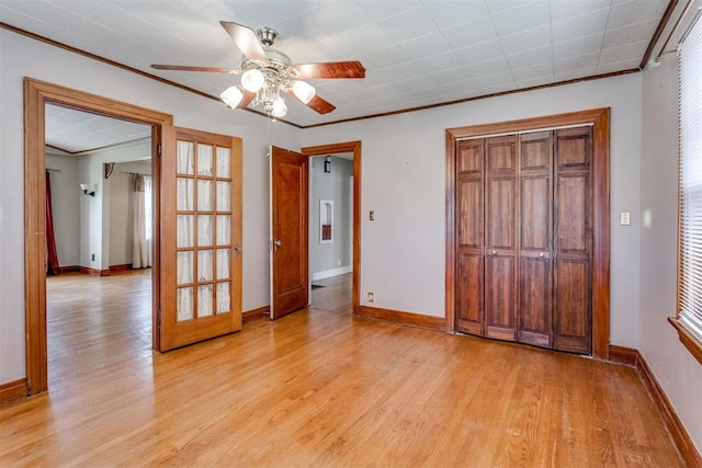 2705 NW 21st St, Oklahoma City, OK 73107 - unfurnished bedroom featuring ornamental molding, light wood-style floors, a closet, and ceiling fan
