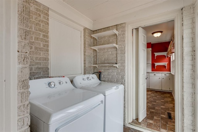 2705 NW 21st St, Oklahoma City, OK 73107 - washroom featuring brick flooring, washing machine and dryer, and crown molding