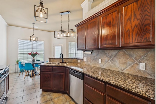 619 SW 28th St, Moore, OK 73160 - kitchen featuring stainless steel appliances, tasteful backsplash, light tile patterned floors, a peninsula, and decorative light fixtures