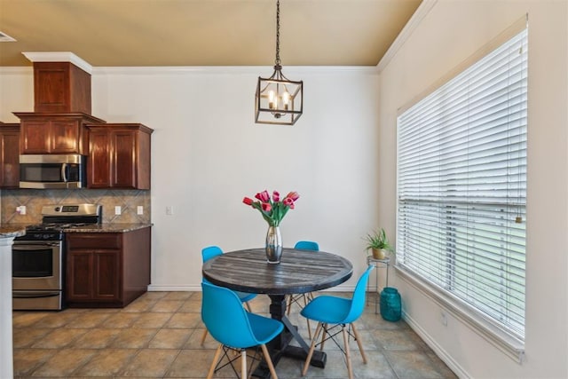 619 SW 28th St, Moore, OK 73160 - dining space featuring a chandelier and ornamental molding