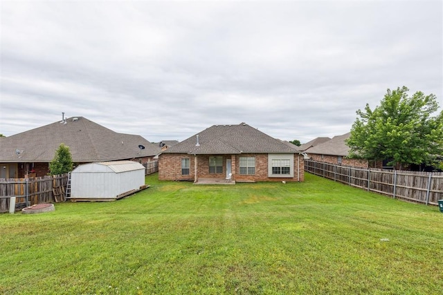619 SW 28th St, Moore, OK 73160 - rear view of property with a fenced backyard, a storage unit, brick siding, and a shingled roof