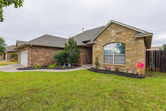 619 SW 28th St, Moore, OK 73160 - view of front of home featuring stone siding, roof with shingles, an attached garage, and driveway