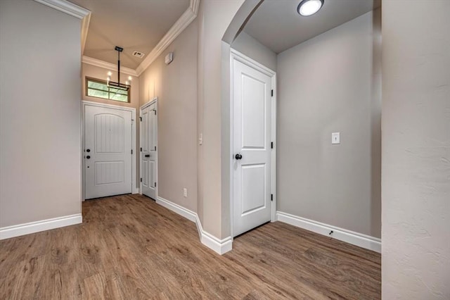 2001 W Crossbow Way, Mustang, OK 73065 - foyer entrance with arched walkways, wood finished floors, ornamental molding, and a chandelier