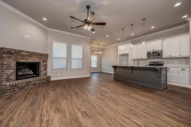 2001 W Crossbow Way, Mustang, OK 73065 - kitchen featuring appliances with stainless steel finishes, open floor plan, dark wood-style flooring, white cabinetry, and a ceiling fan