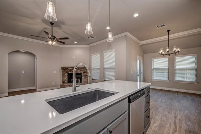 2001 W Crossbow Way, Mustang, OK 73065 - kitchen featuring stainless steel dishwasher, open floor plan, a ceiling fan, a brick fireplace, and pendant lighting