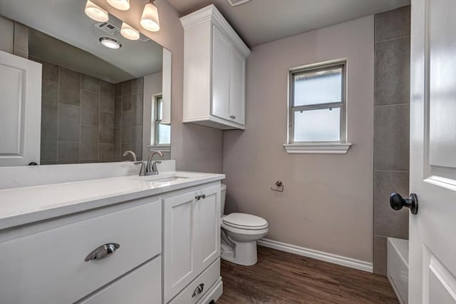 2001 W Crossbow Way, Mustang, OK 73065 - bathroom with vanity, plenty of natural light, wood finished floors, and bathing tub / shower combination