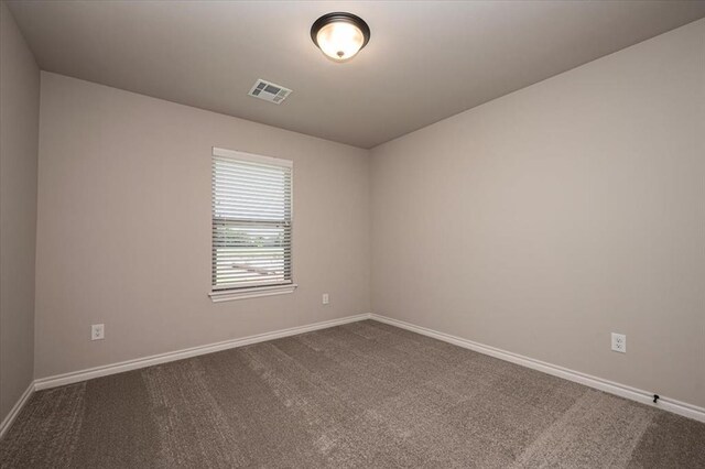 2001 W Crossbow Way, Mustang, OK 73065 - spare room with dark colored carpet