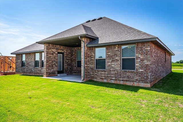 2001 W Crossbow Way, Mustang, OK 73065 - back of house with brick siding, roof with shingles, and a patio